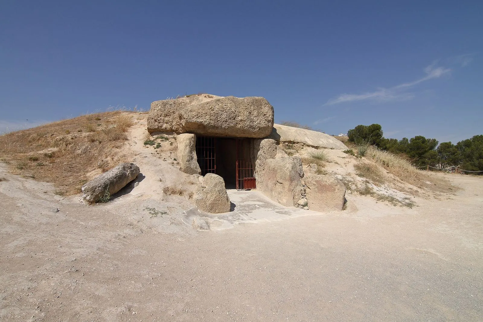 The entrance to the Dolmen de Menga in Antequera, a prehistoric tomb roofed with huge stone slabs