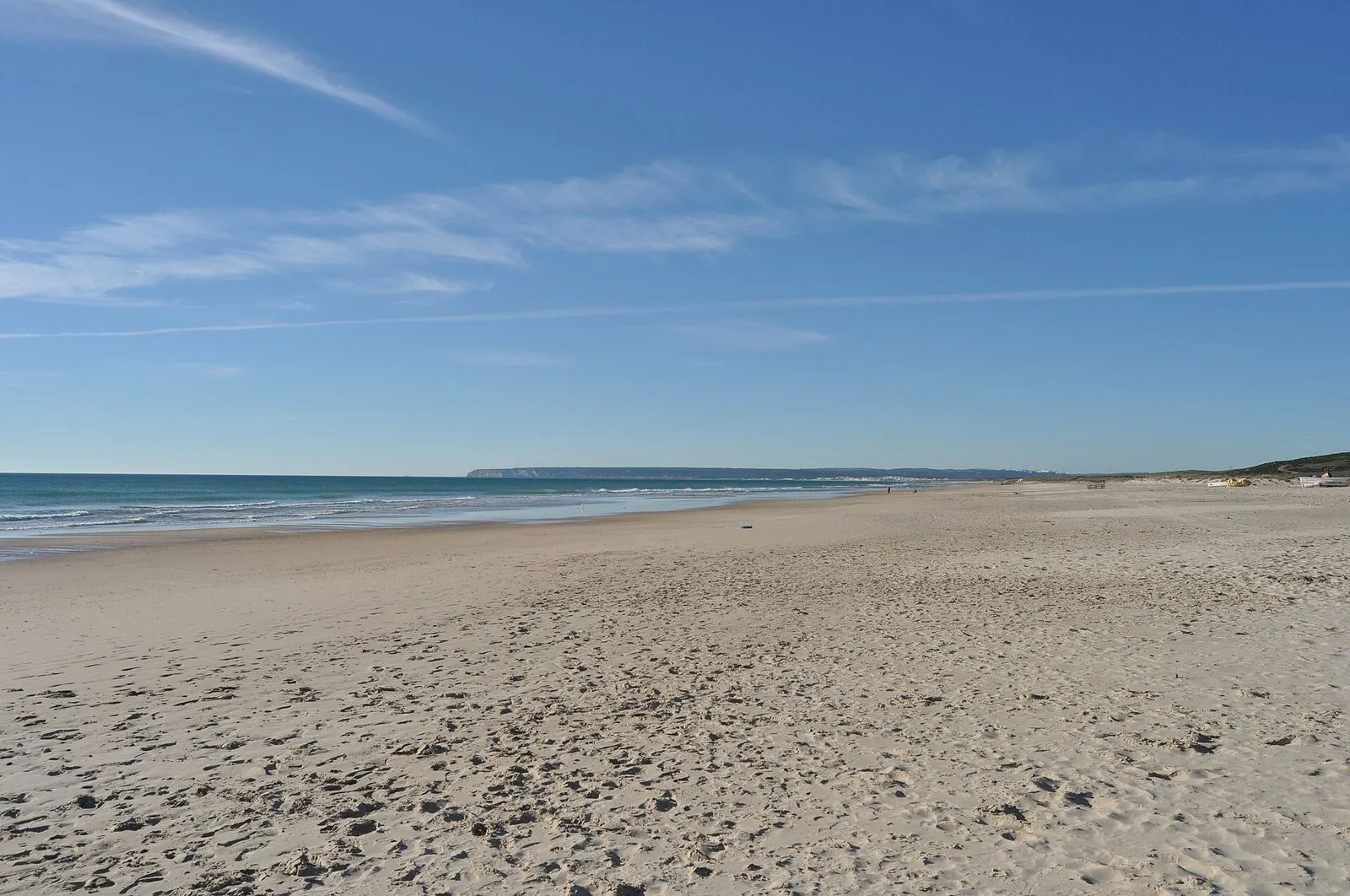 The long, almost empty sandy beach at Zahara de los Atunes under a blue sky